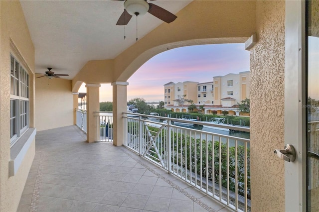 14041 Bellagio Way Unit 214, Osprey, FL 34229 - balcony featuring a ceiling fan and a water view