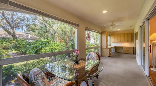 sunroom featuring ceiling fan