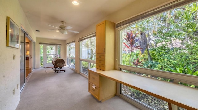 sunroom / solarium featuring ceiling fan