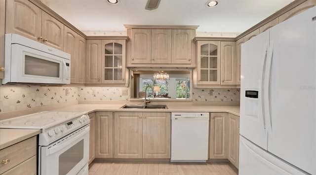 kitchen featuring a notable chandelier, sink, light brown cabinetry, and white appliances