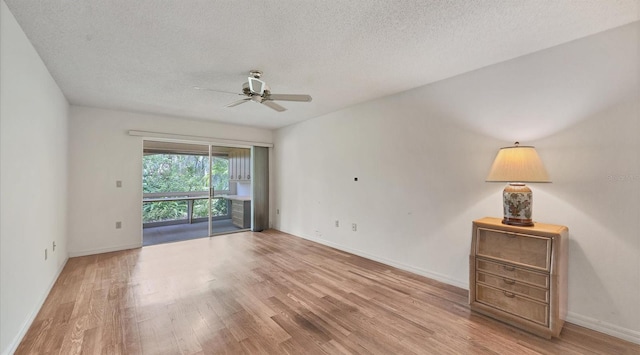 spare room with light hardwood / wood-style floors, a textured ceiling, and ceiling fan