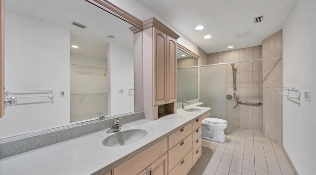 bathroom featuring vanity, tile patterned floors, toilet, and walk in shower