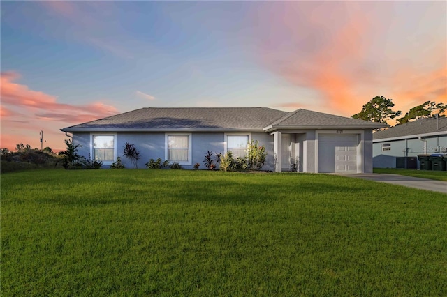 view of front of house featuring a yard and a garage