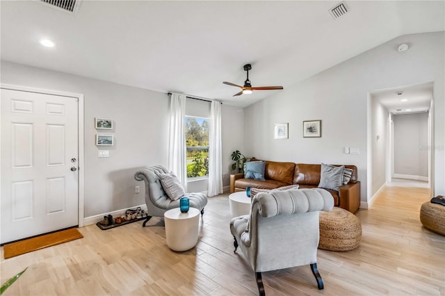 living room featuring ceiling fan, lofted ceiling, and light hardwood / wood-style flooring