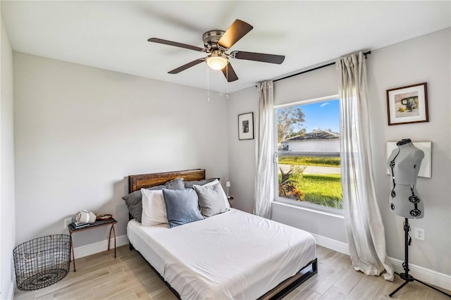 bedroom featuring light hardwood / wood-style floors and ceiling fan