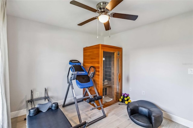 exercise area with light hardwood / wood-style flooring and ceiling fan