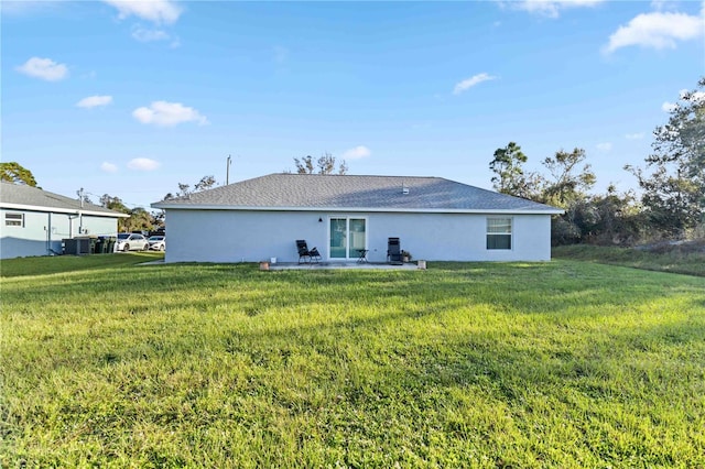 rear view of property with a yard and a patio