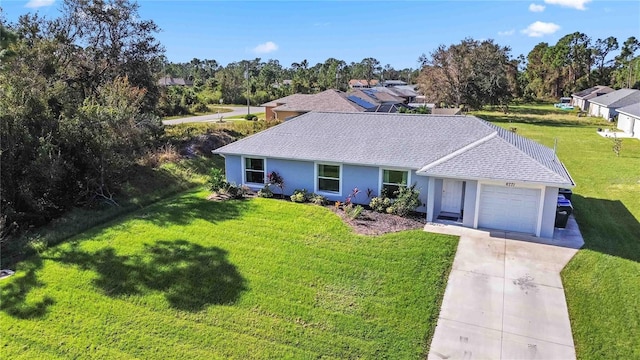 ranch-style home with a front lawn and a garage