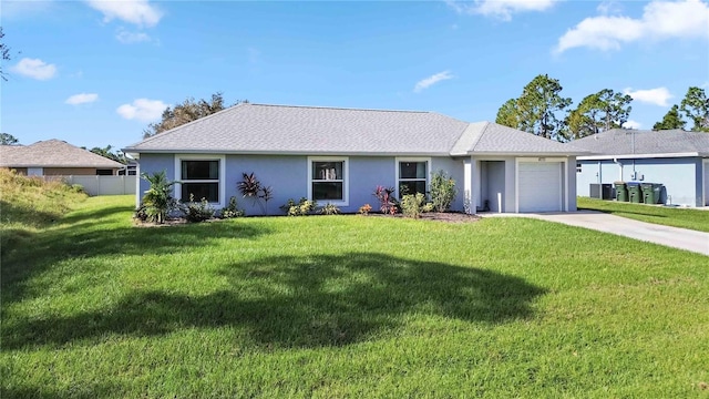 single story home featuring a garage and a front lawn