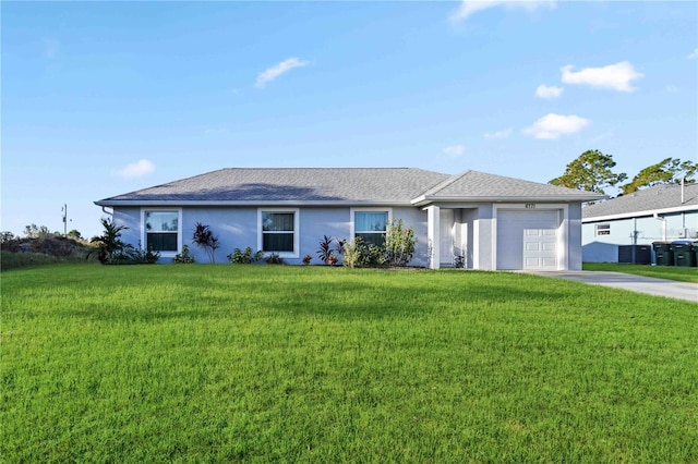 ranch-style house featuring a front yard and a garage