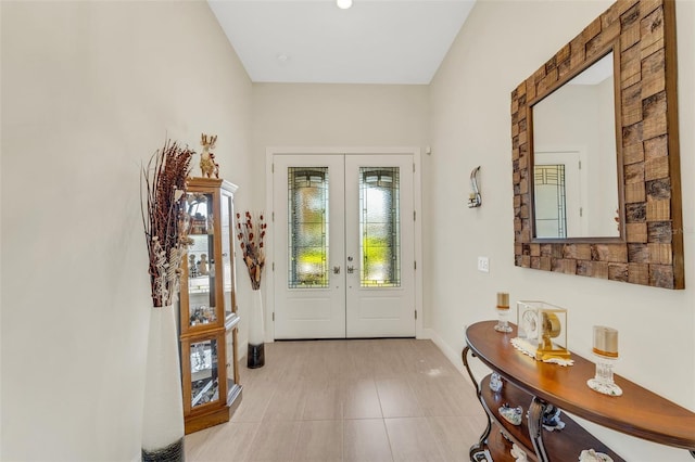 tiled foyer with french doors and a healthy amount of sunlight