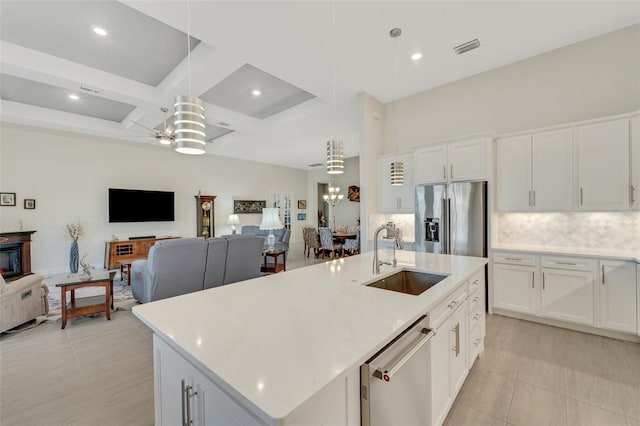 kitchen featuring white cabinetry, stainless steel appliances, and pendant lighting