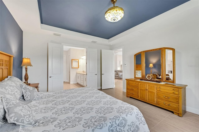 tiled bedroom featuring ensuite bathroom