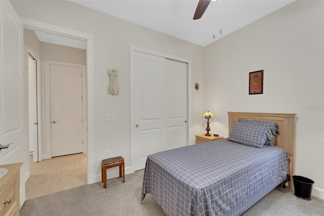 carpeted bedroom with a closet and ceiling fan