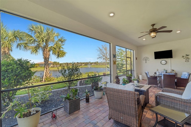 sunroom featuring ceiling fan