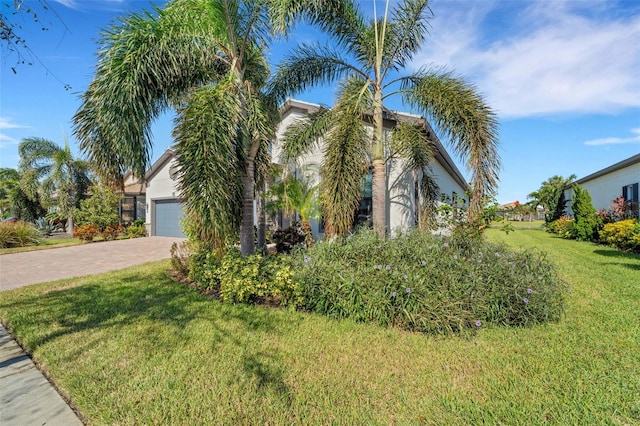 view of front facade with a front yard and a garage