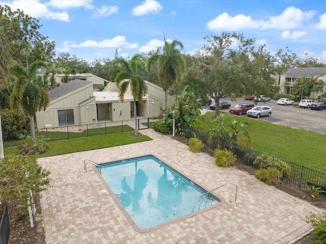 view of pool featuring a patio and a lawn