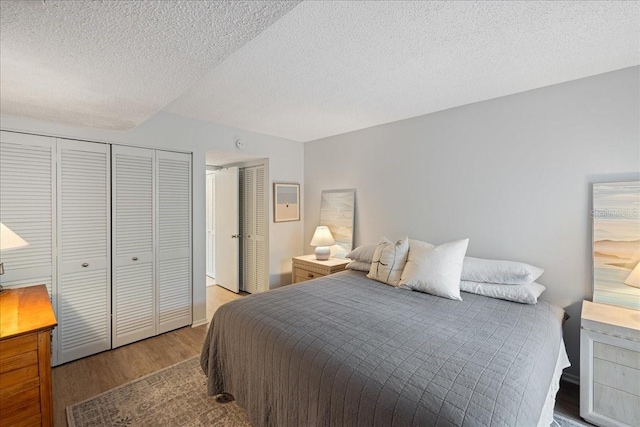 bedroom with a textured ceiling and hardwood / wood-style floors