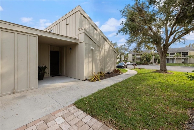 view of side of home with a yard