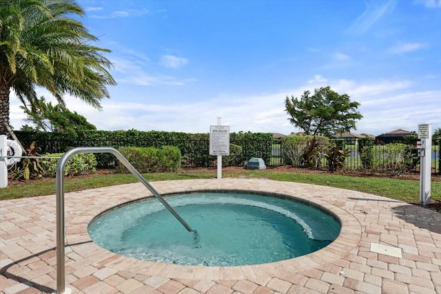 view of swimming pool featuring a hot tub