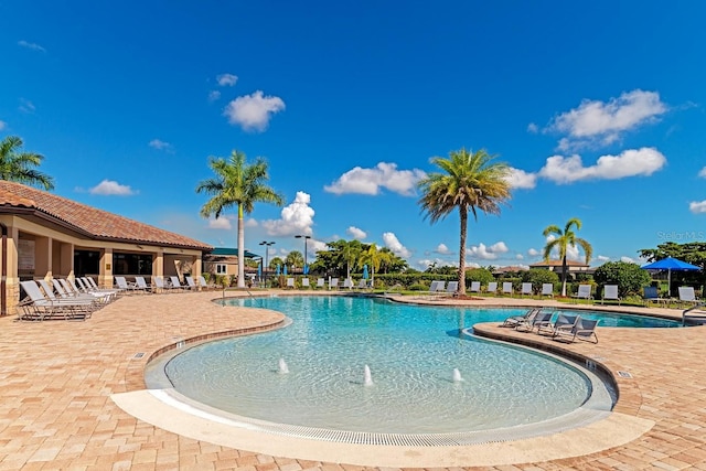 view of pool featuring pool water feature and a patio area