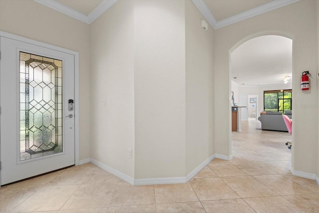 tiled entryway featuring crown molding