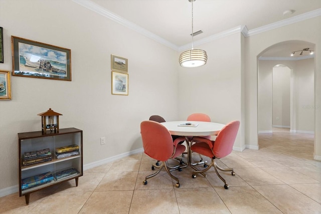 dining area with light tile patterned floors and ornamental molding