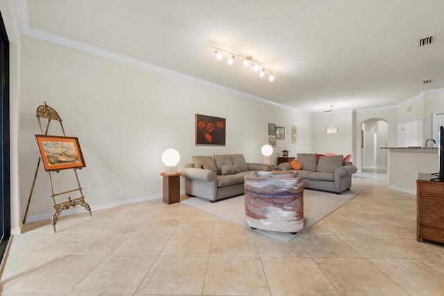 living room featuring light tile patterned floors and ornamental molding