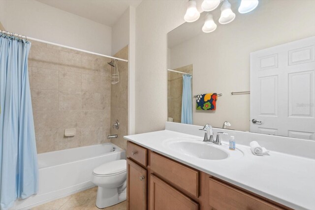 full bathroom featuring toilet, vanity, tile patterned floors, and shower / bathtub combination with curtain