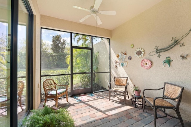 unfurnished sunroom featuring lofted ceiling and ceiling fan