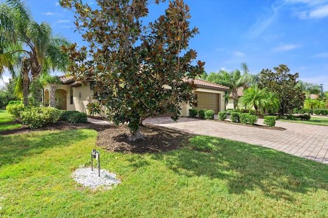 mediterranean / spanish-style home with a garage and a front yard