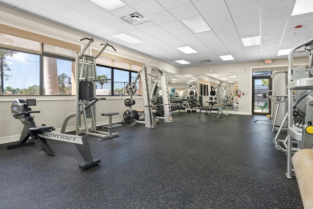 exercise room with a wealth of natural light and a paneled ceiling