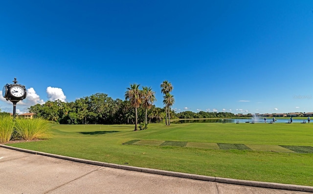 view of home's community with a lawn and a water view