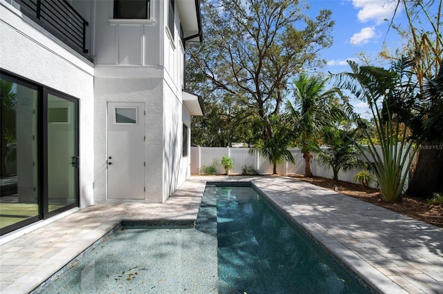 view of swimming pool with a jacuzzi