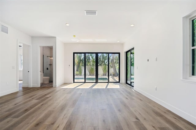 unfurnished living room with light hardwood / wood-style floors