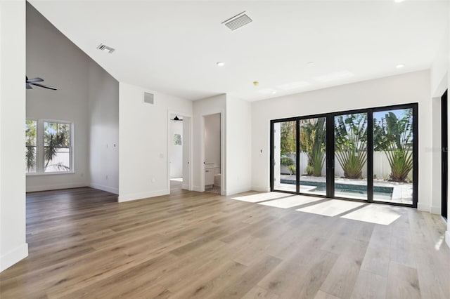 unfurnished room with ceiling fan and light hardwood / wood-style floors