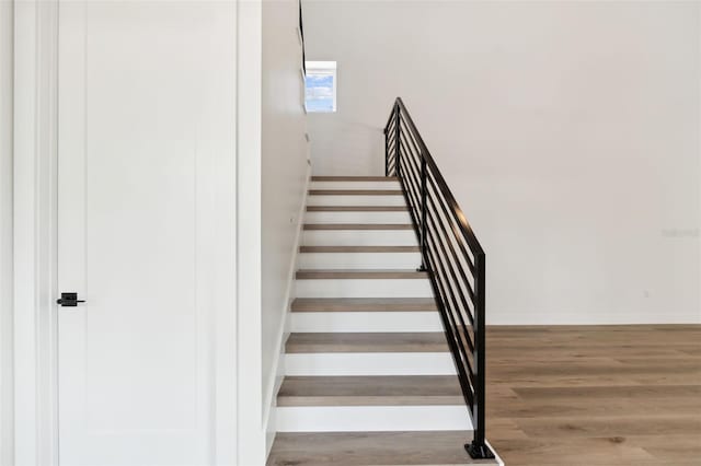 stairs with hardwood / wood-style flooring