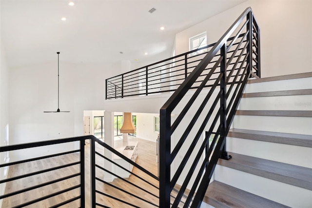 stairs featuring hardwood / wood-style floors