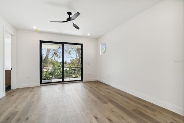 empty room with ceiling fan and light wood-type flooring