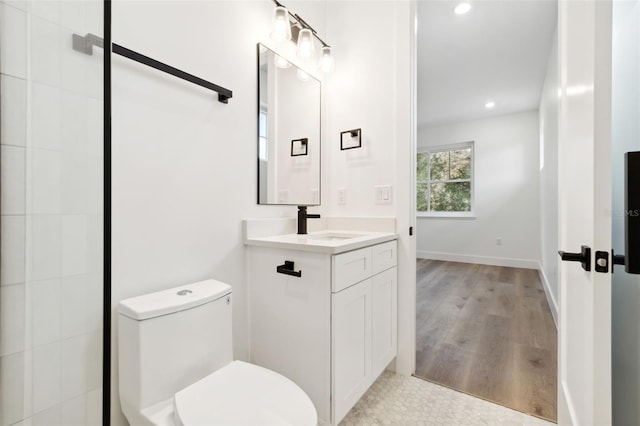 bathroom with hardwood / wood-style floors, vanity, and toilet