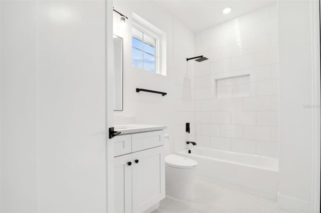 full bathroom featuring tile patterned flooring, vanity, toilet, and tiled shower / bath combo