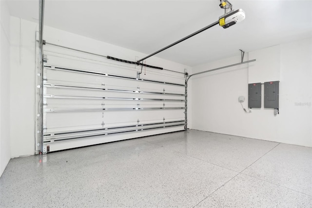 garage featuring electric panel and a garage door opener