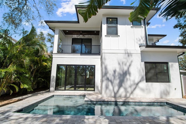 back of house featuring ceiling fan and a balcony