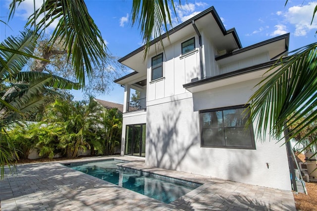 rear view of property featuring a balcony