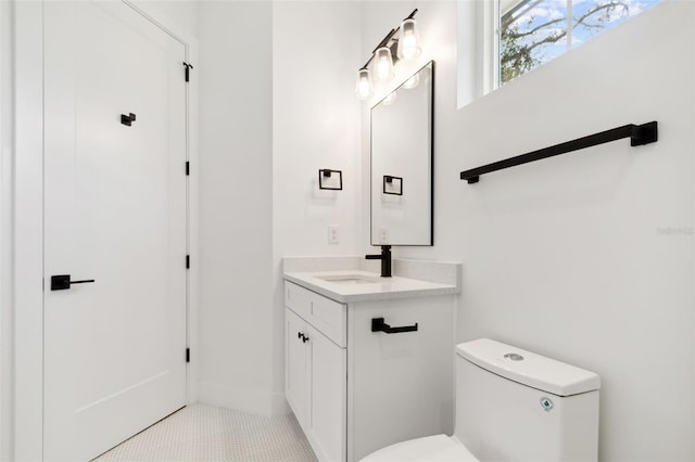 bathroom featuring tile patterned flooring, vanity, and toilet