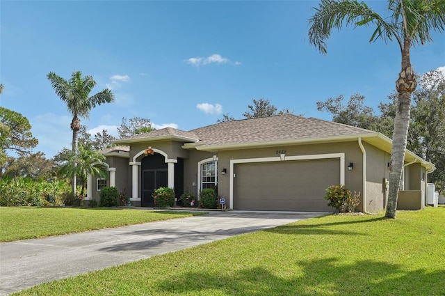 view of front of house with a front lawn and a garage