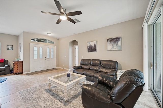 living room with plenty of natural light, ceiling fan, and light tile patterned floors