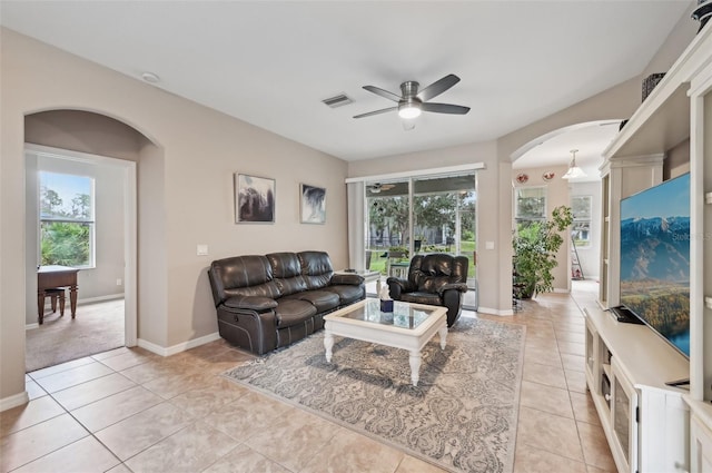 living room with a healthy amount of sunlight, ceiling fan, and light tile patterned floors