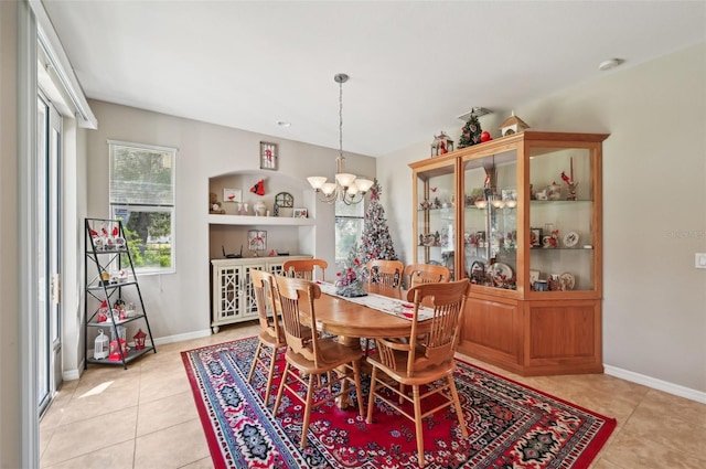 tiled dining area with a chandelier