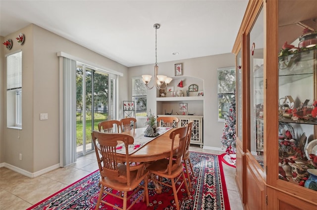 tiled dining room featuring a chandelier